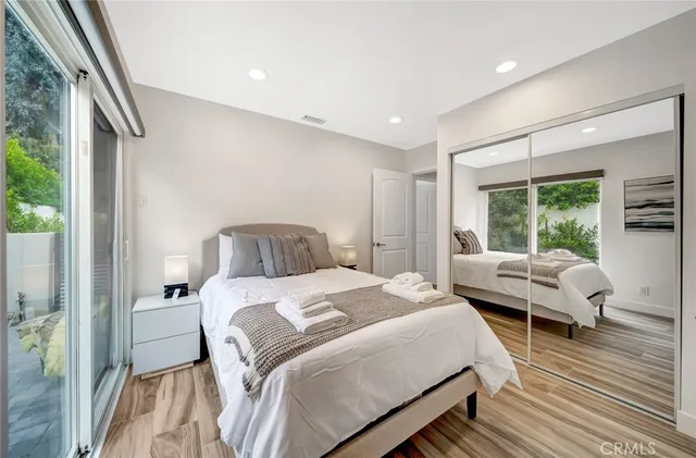 a spacious bedroom with a bed and a mirror