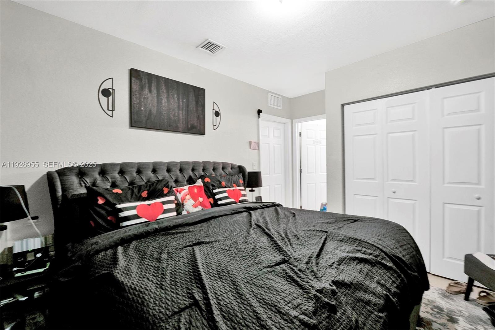 1910 Northwest 72nd Street Miami, FL 33147 - Photo 11 of 37 a bedroom with a bed and a couch