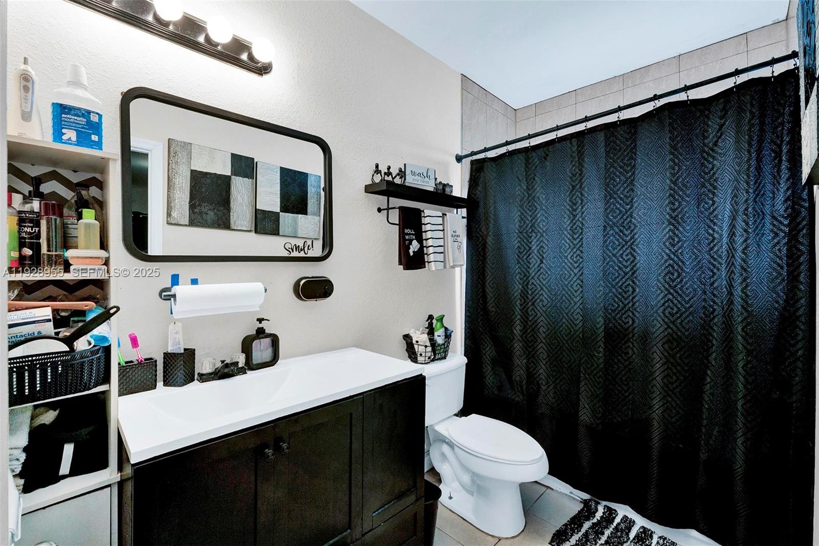 1910 Northwest 72nd Street Miami, FL 33147 - Photo 12 of 37 a bathroom with a sink and a mirror