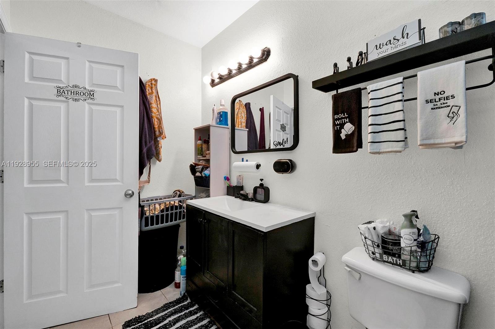 1910 Northwest 72nd Street Miami, FL 33147 - Photo 13 of 37 a bathroom with a sink and a mirror