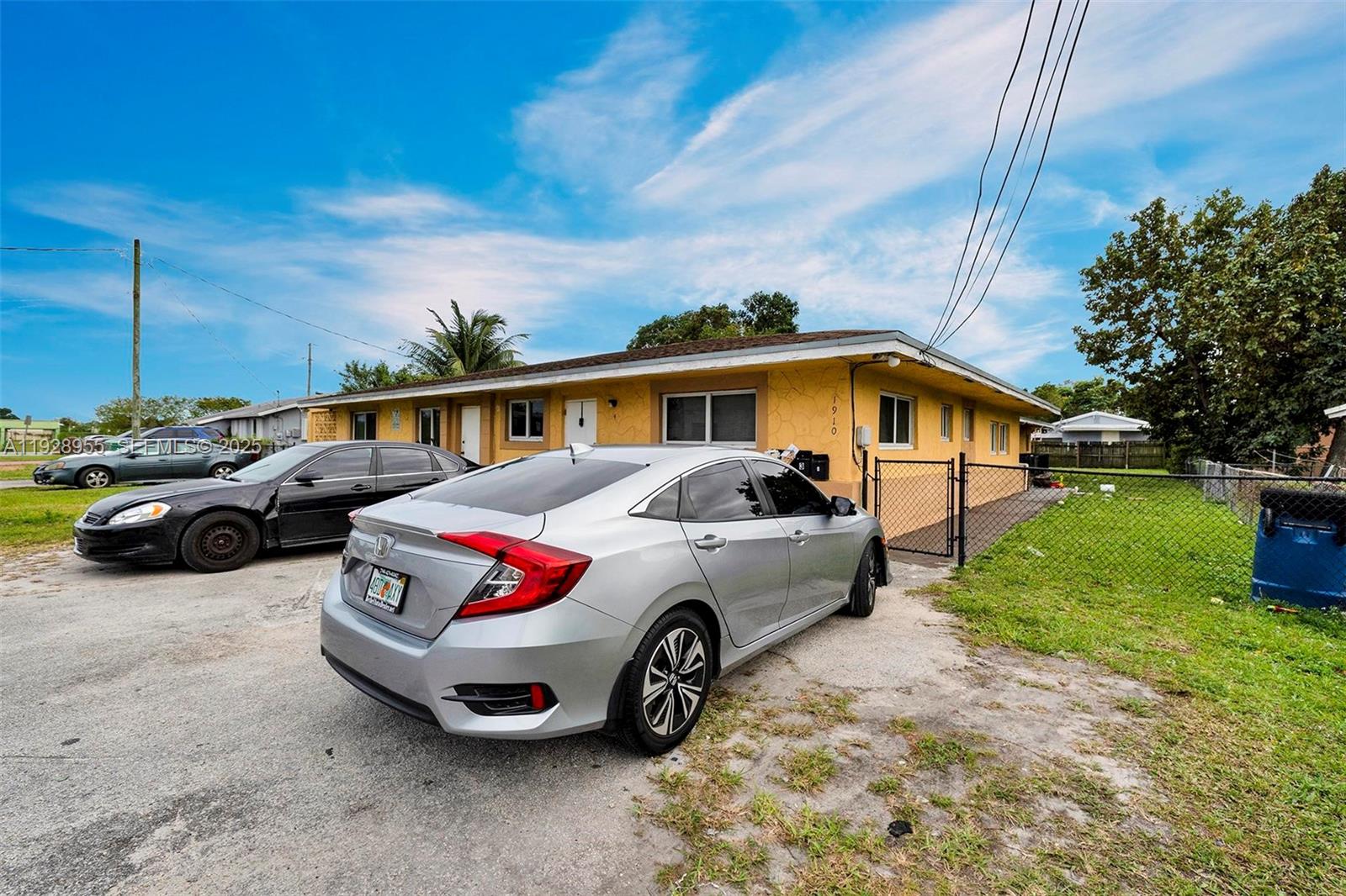 1910 Northwest 72nd Street Miami, FL 33147 - Photo 2 of 37 a front view of a house with cars parked