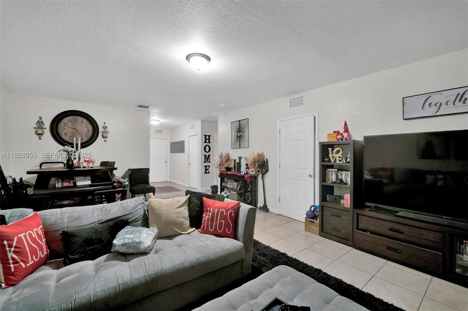 1910 Northwest 72nd Street Miami, FL 33147 - Photo 21 of 37 a living room with furniture and a flat screen tv