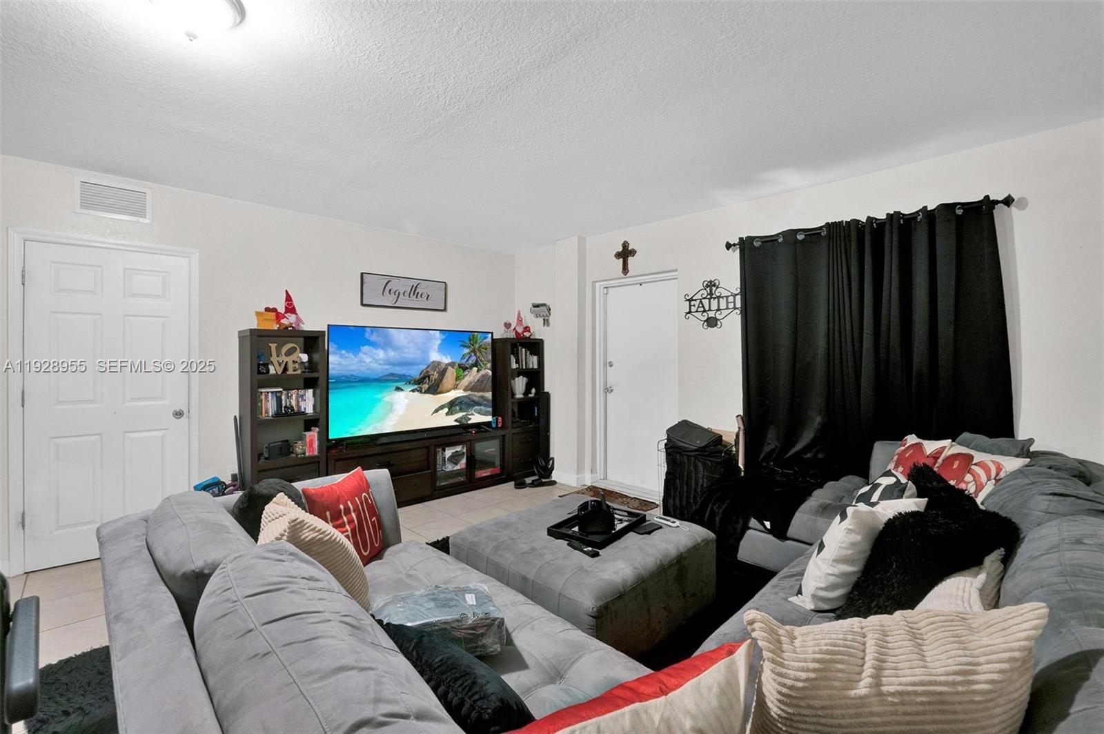 1910 Northwest 72nd Street Miami, FL 33147 - Photo 23 of 37 a living room with furniture and a bed