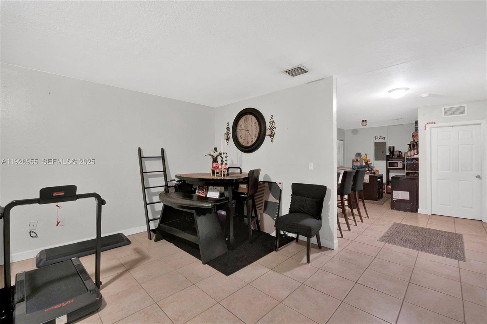 1910 Northwest 72nd Street Miami, FL 33147 - Photo 24 of 37 a dining room with furniture and a mirror