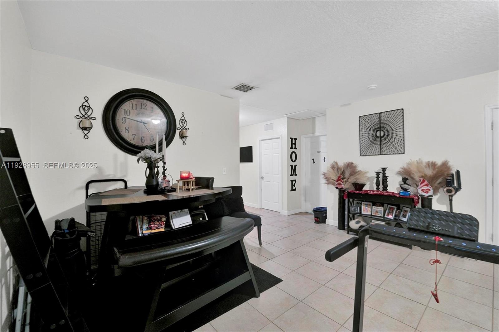 1910 Northwest 72nd Street Miami, FL 33147 - Photo 25 of 37 a living room with furniture a mirror and a piano