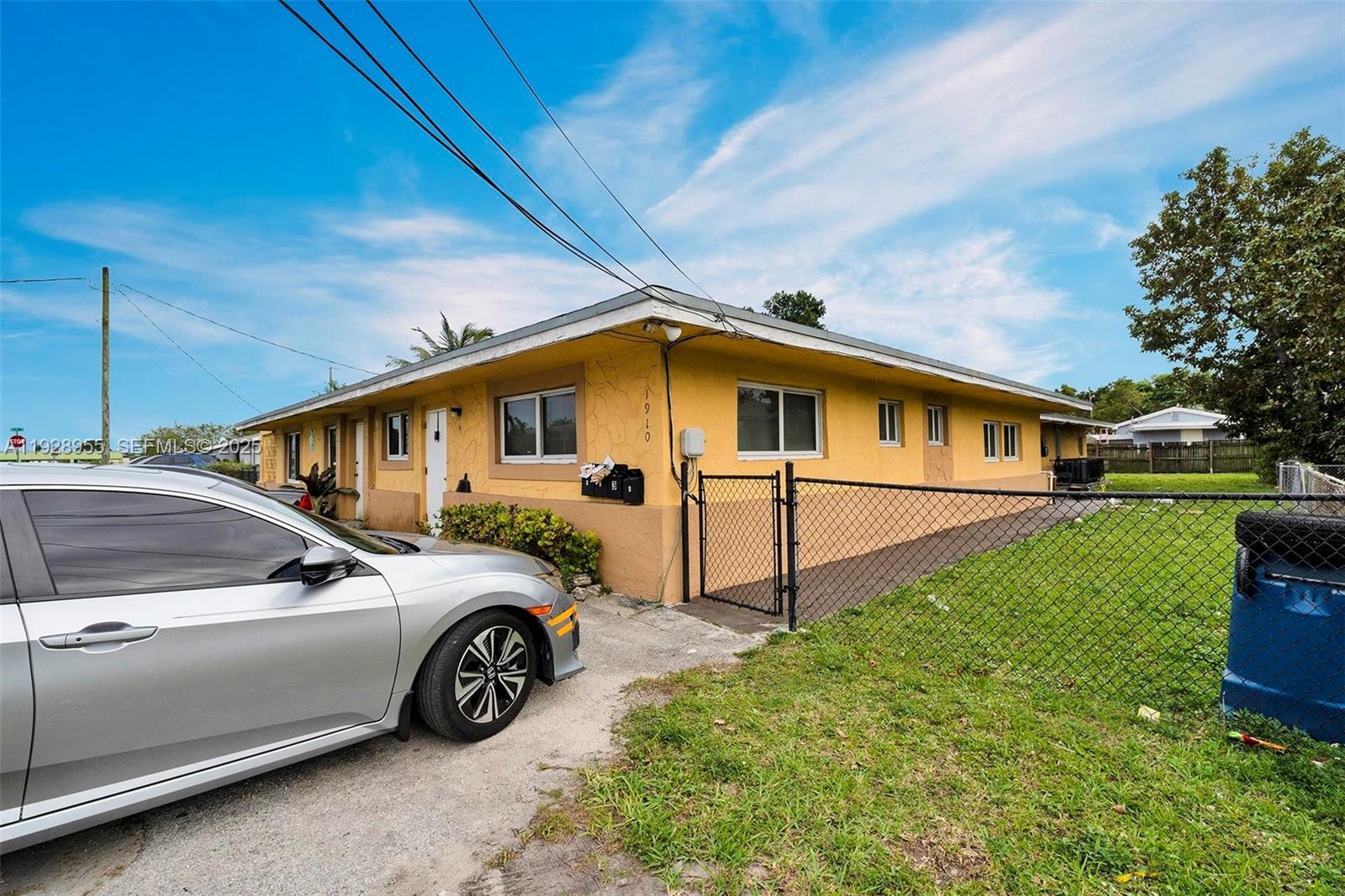 1910 Northwest 72nd Street Miami, FL 33147 - Photo 3 of 37 a front view of a house with a yard