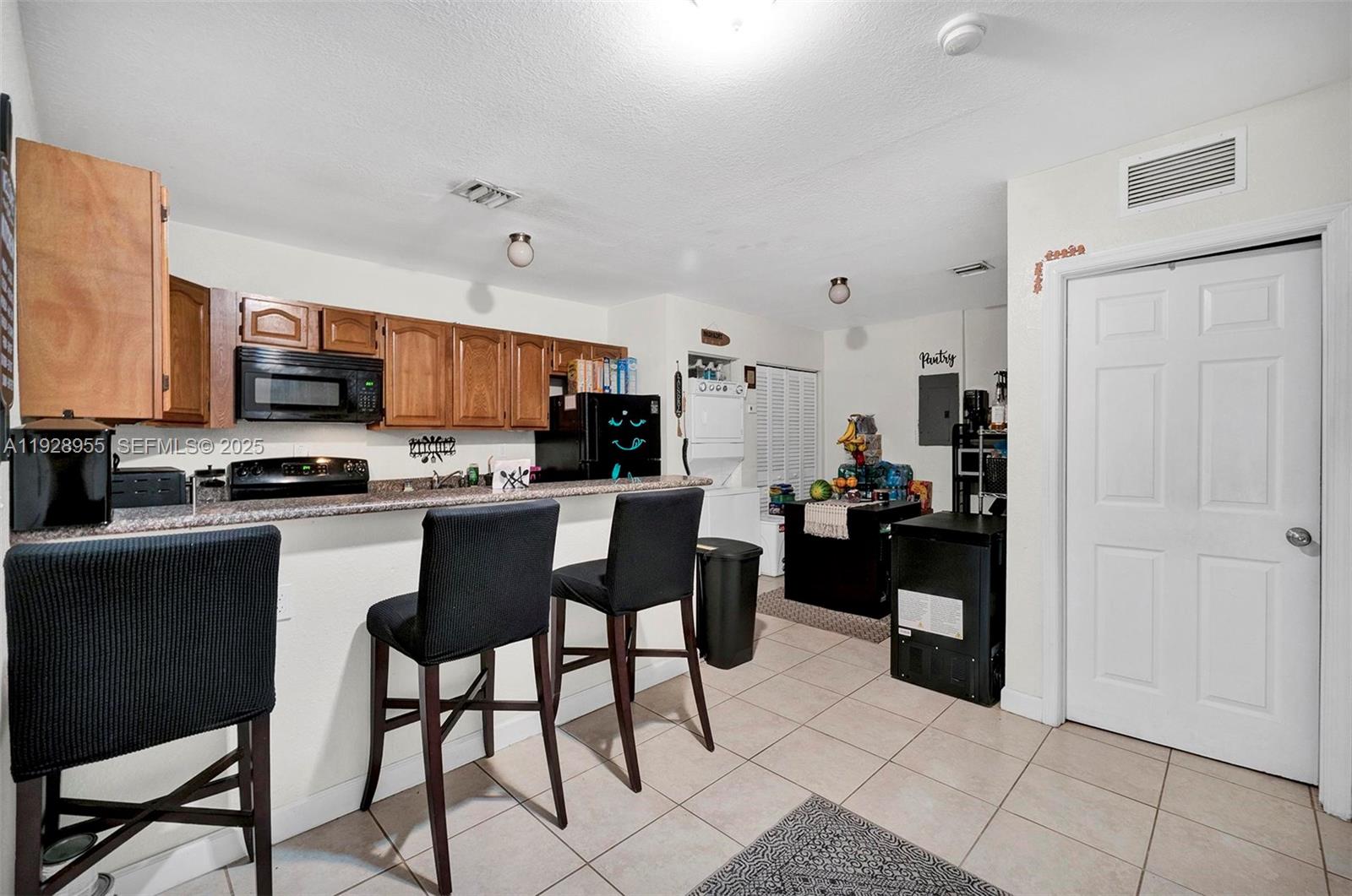 1910 Northwest 72nd Street Miami, FL 33147 - Photo 6 of 37 a kitchen with stainless steel appliances a refrigerator and a stove top oven