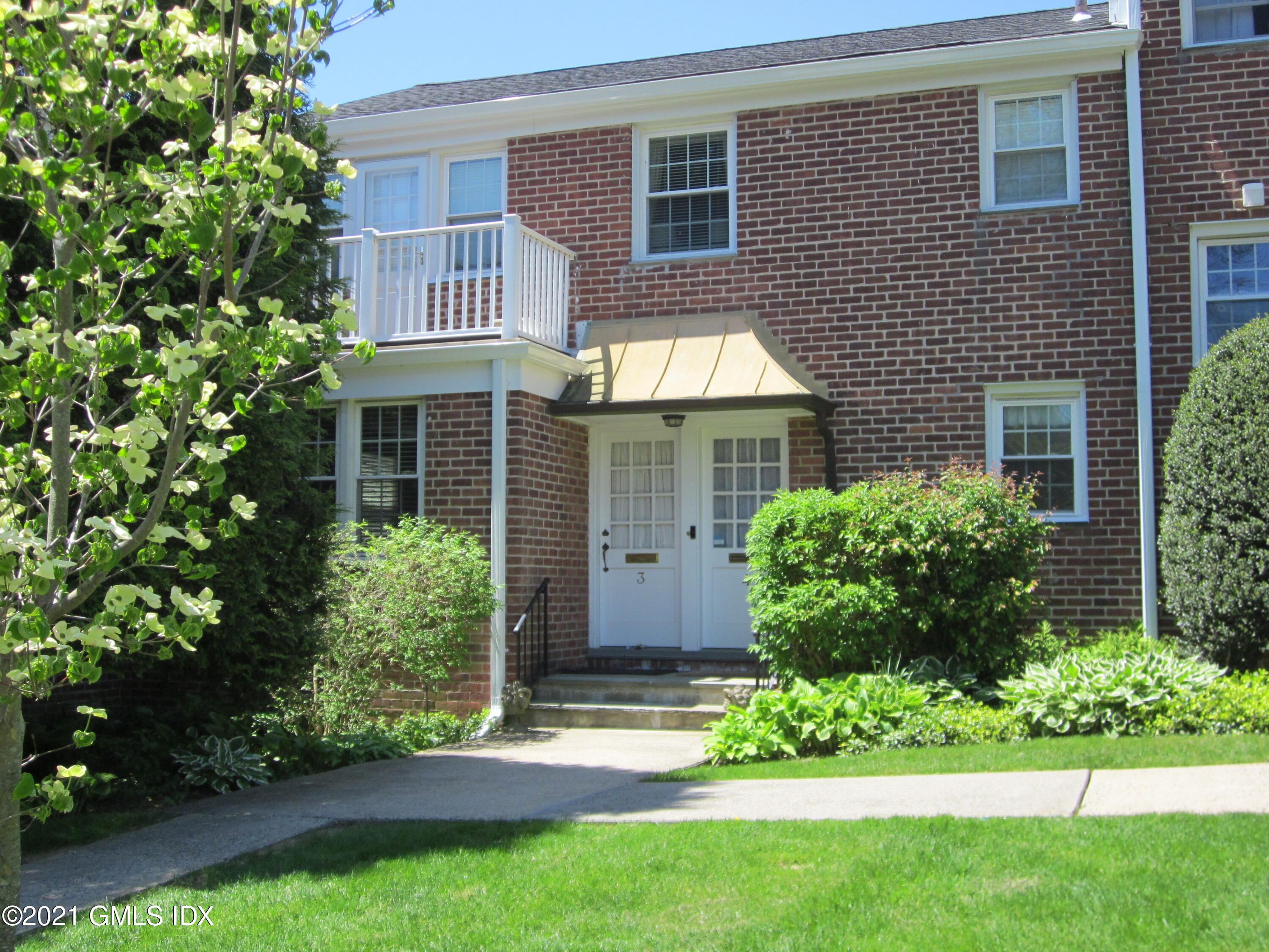 4 Putnam Park, Unit 4 Greenwich, CT 06830 - Photo 1 of 37 a view of a house with a yard and plants