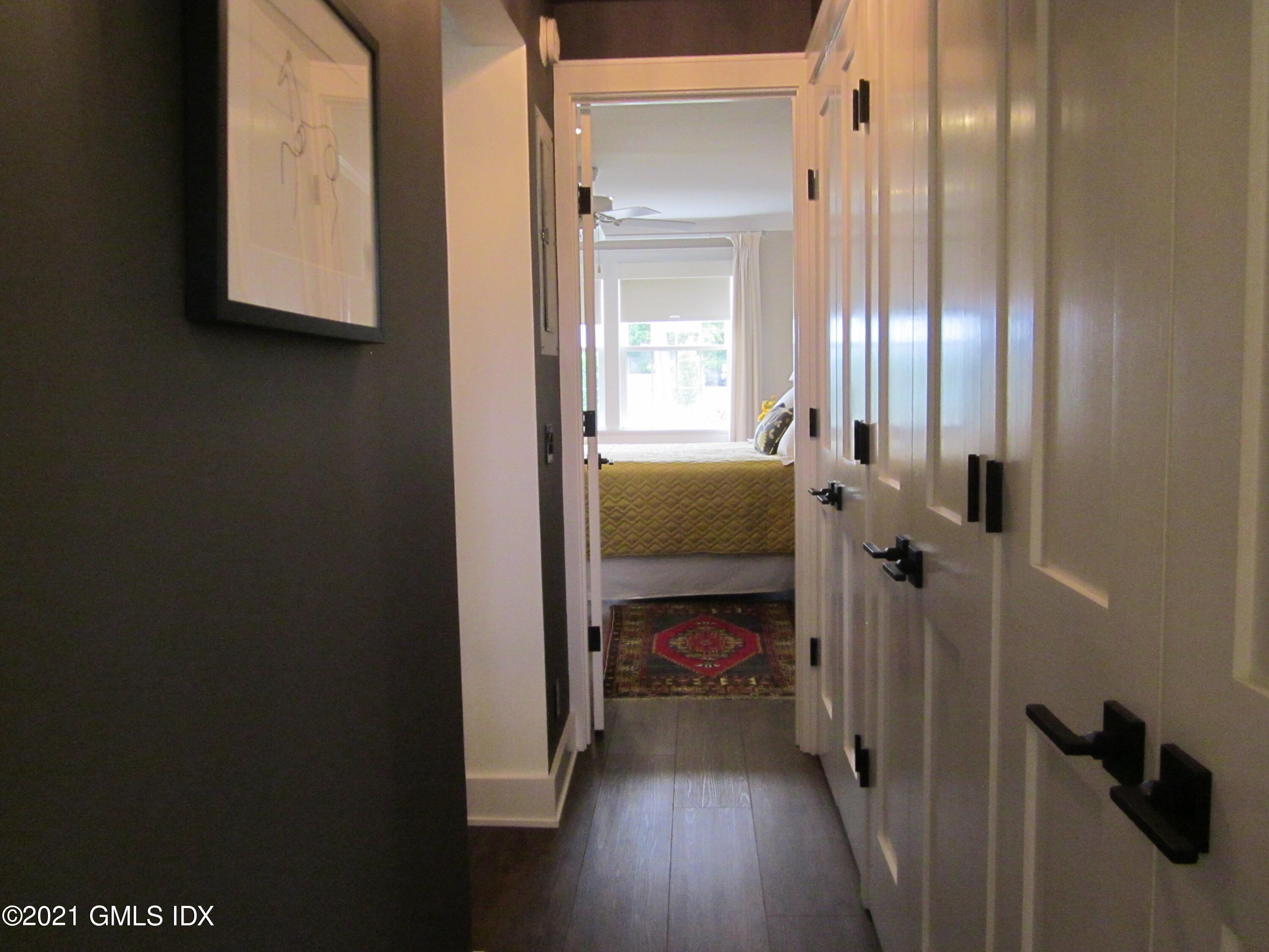 4 Putnam Park, Unit 4 Greenwich, CT 06830 - Photo 10 of 37 a bedroom with a bed and a mirror