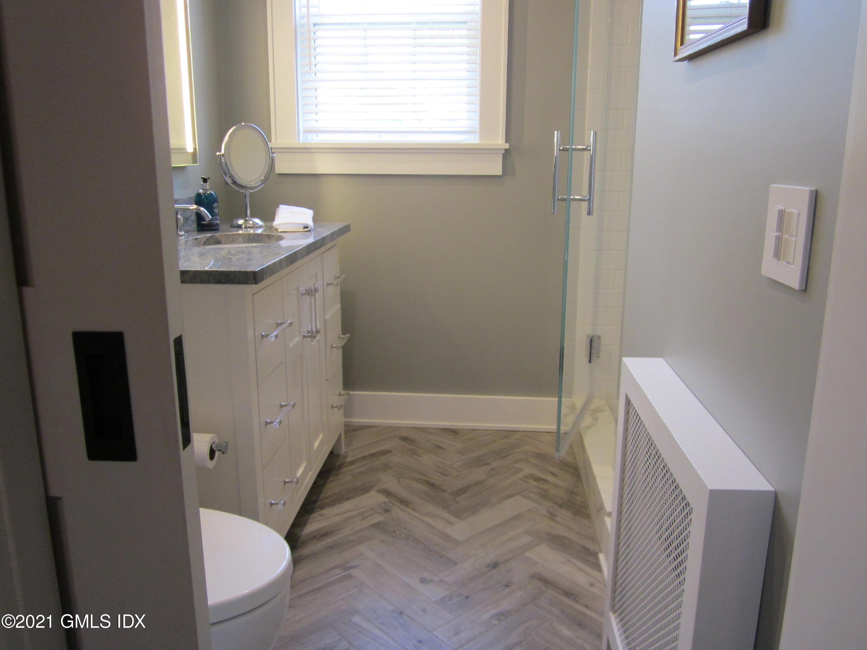 4 Putnam Park, Unit 4 Greenwich, CT 06830 - Photo 12 of 37 a bathroom with a sink toilet and shower