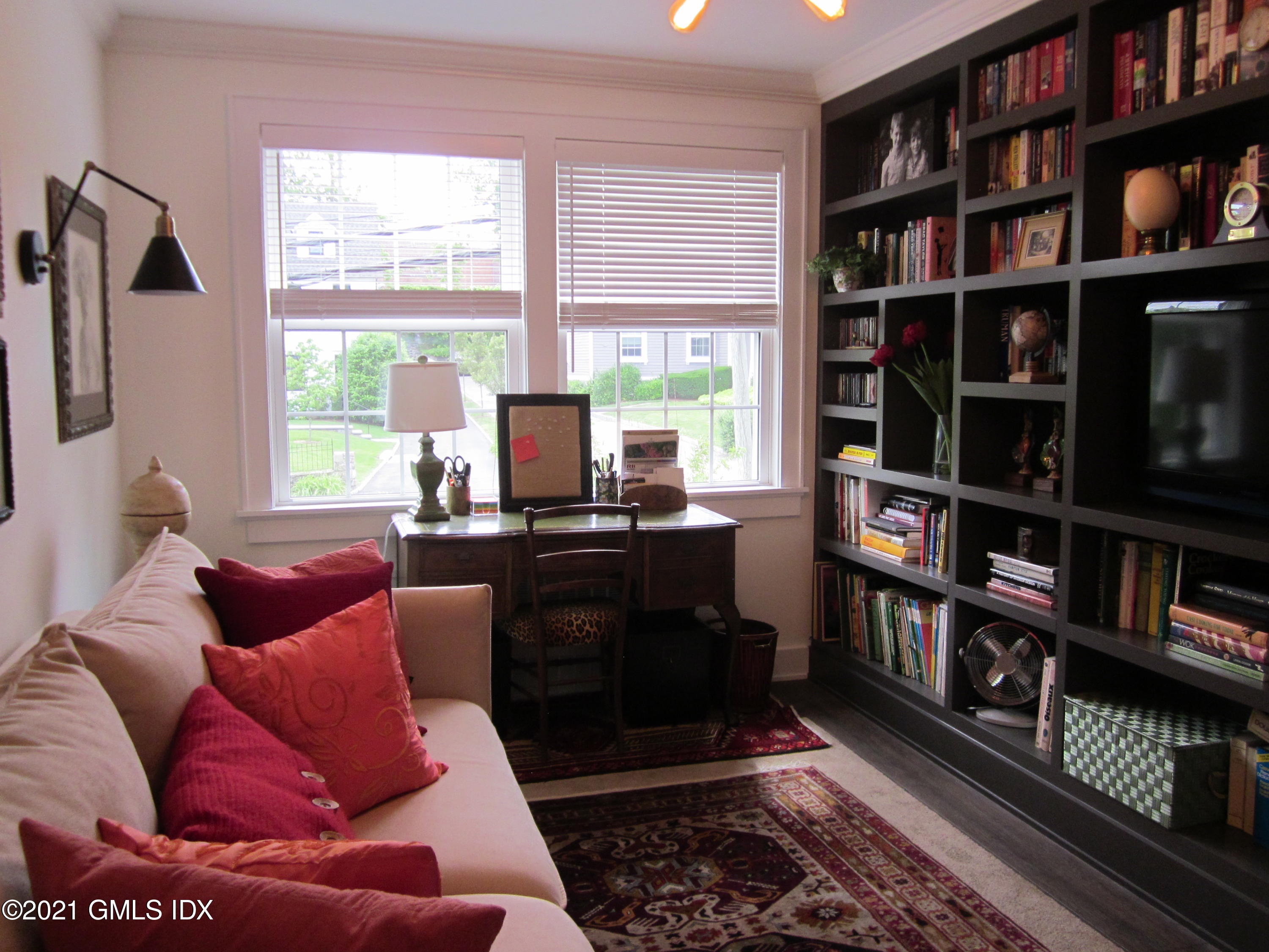 4 Putnam Park, Unit 4 Greenwich, CT 06830 - Photo 15 of 37 a living room with furniture and a book shelf