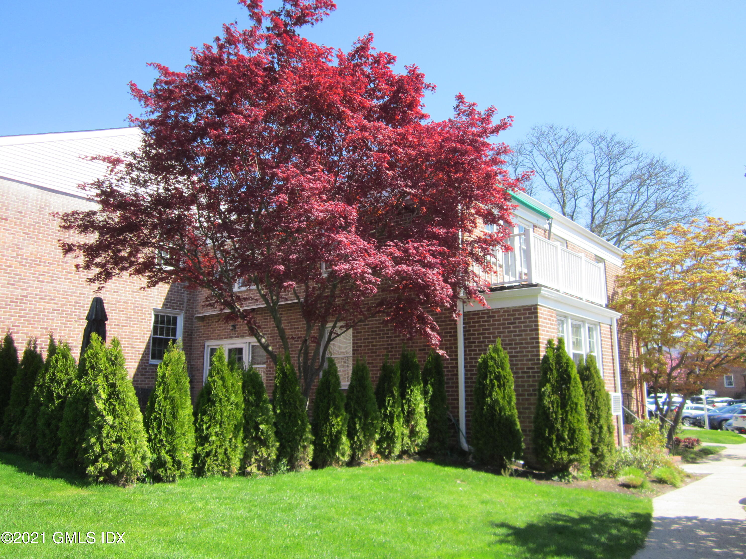 4 Putnam Park, Unit 4 Greenwich, CT 06830 - Photo 24 of 37 a front view of a house with garden