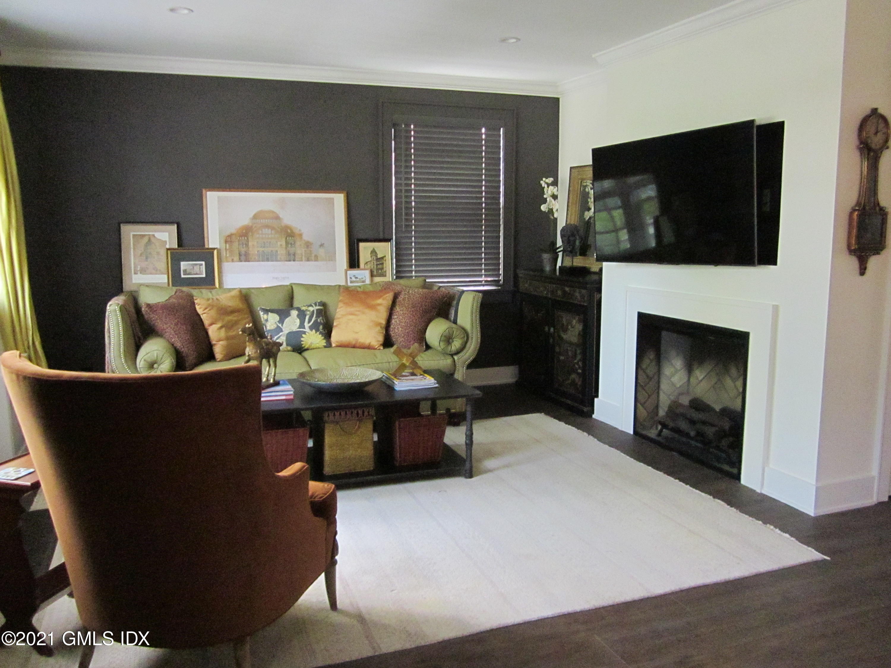4 Putnam Park, Unit 4 Greenwich, CT 06830 - Photo 4 of 37 a living room with furniture and a fireplace