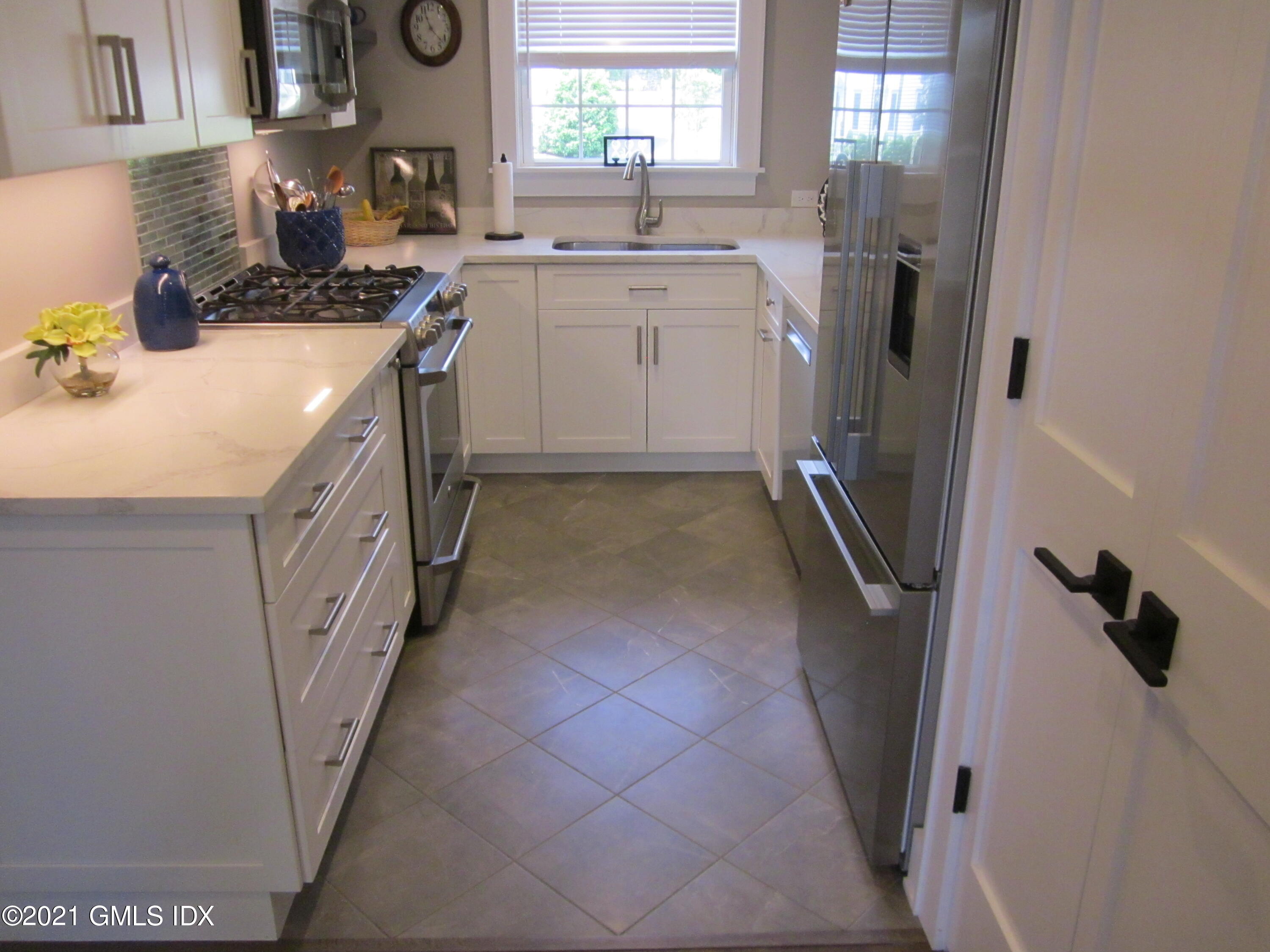 4 Putnam Park, Unit 4 Greenwich, CT 06830 - Photo 8 of 37 a kitchen with a sink cabinets and window