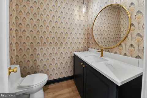 a large kitchen with stainless steel appliances a large counter top a sink a refrigerator and a window