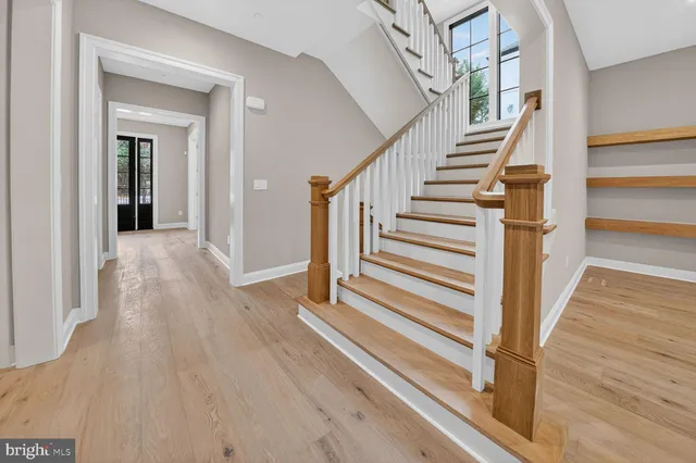 a view of a bathroom from a hallway with wooden floor