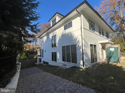 a view of a white house with a yard