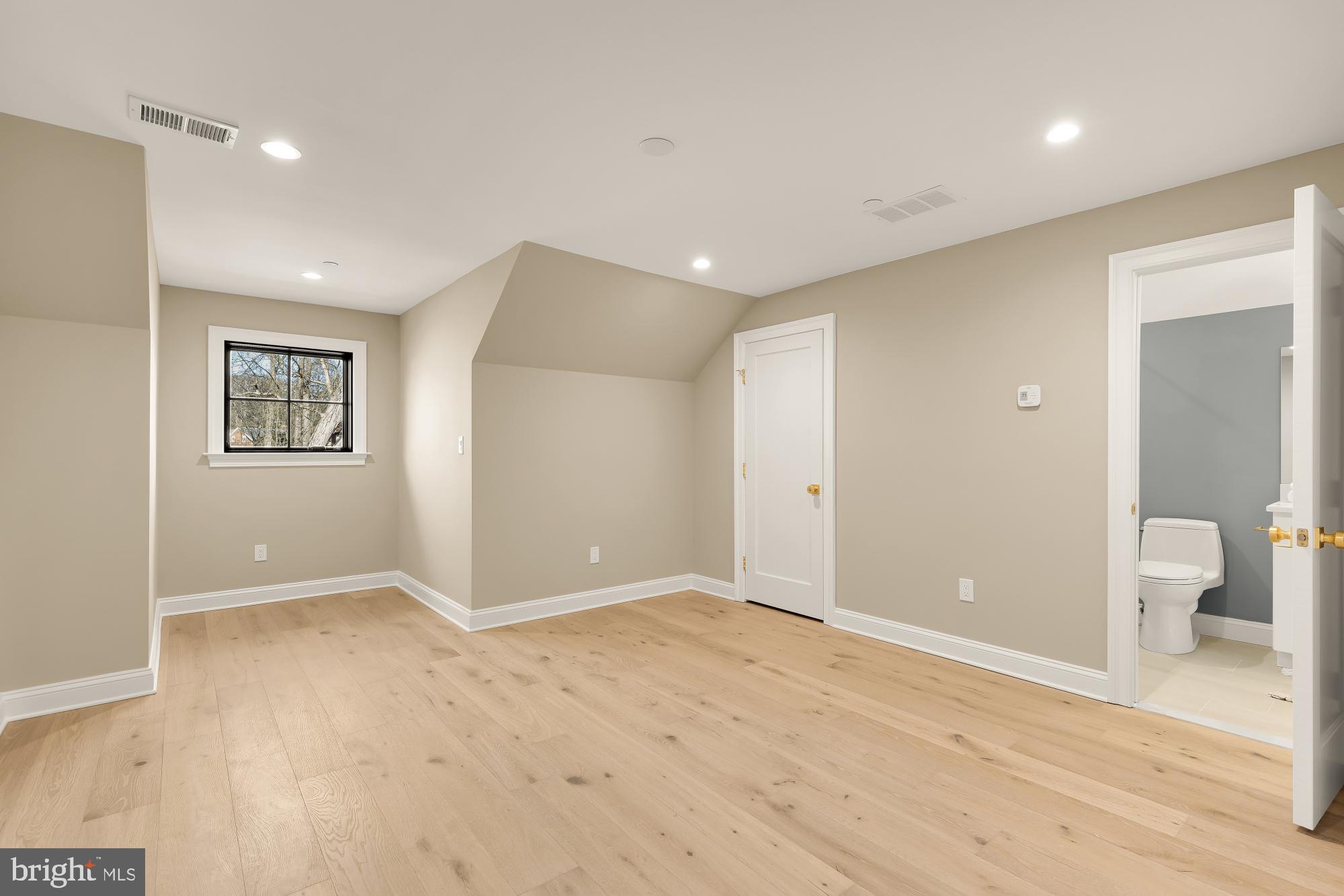 2733 Chesapeake Street Northwest Washington, DC 20008 - Photo 72 of 97 a view of an empty room with wooden floor and a window
