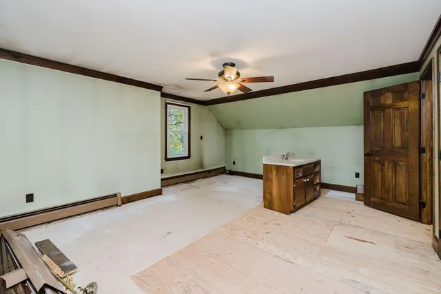 a view of a livingroom with furniture and chandelier fan