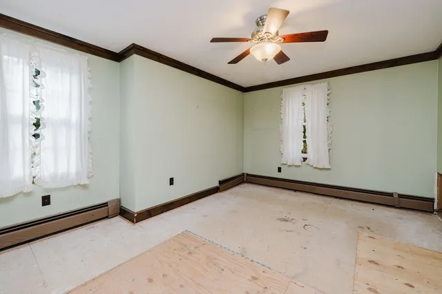 an empty room with closet and a ceiling fan