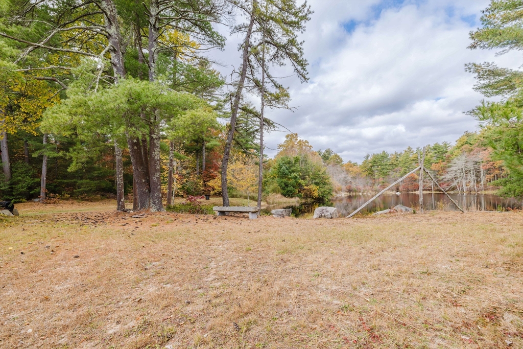 150 Quanapoag Road Freetown, MA 02717 - Photo 4 of 42 a backyard of a house with large trees