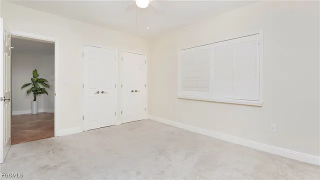 a bathroom with a granite countertop sink a toilet a mirror and shower