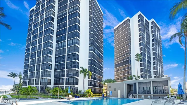 a view of a swimming pool with a table and chairs in balcony