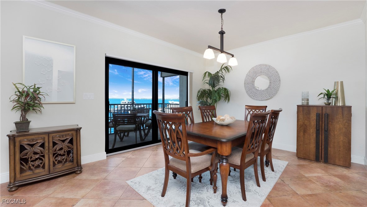 1920 Virginia Avenue, Unit 202 Fort Myers, FL 33901 - Photo 6 of 38 a view of a dining room with furniture and a chandelier