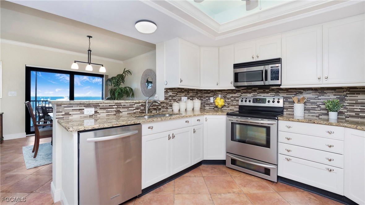 1920 Virginia Avenue, Unit 202 Fort Myers, FL 33901 - Photo 7 of 38 a kitchen with granite countertop a sink stove and microwave