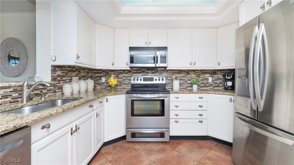 1920 Virginia Avenue, Unit 202 Fort Myers, FL 33901 - Photo 8 of 38 a kitchen with granite countertop a refrigerator stove and sink