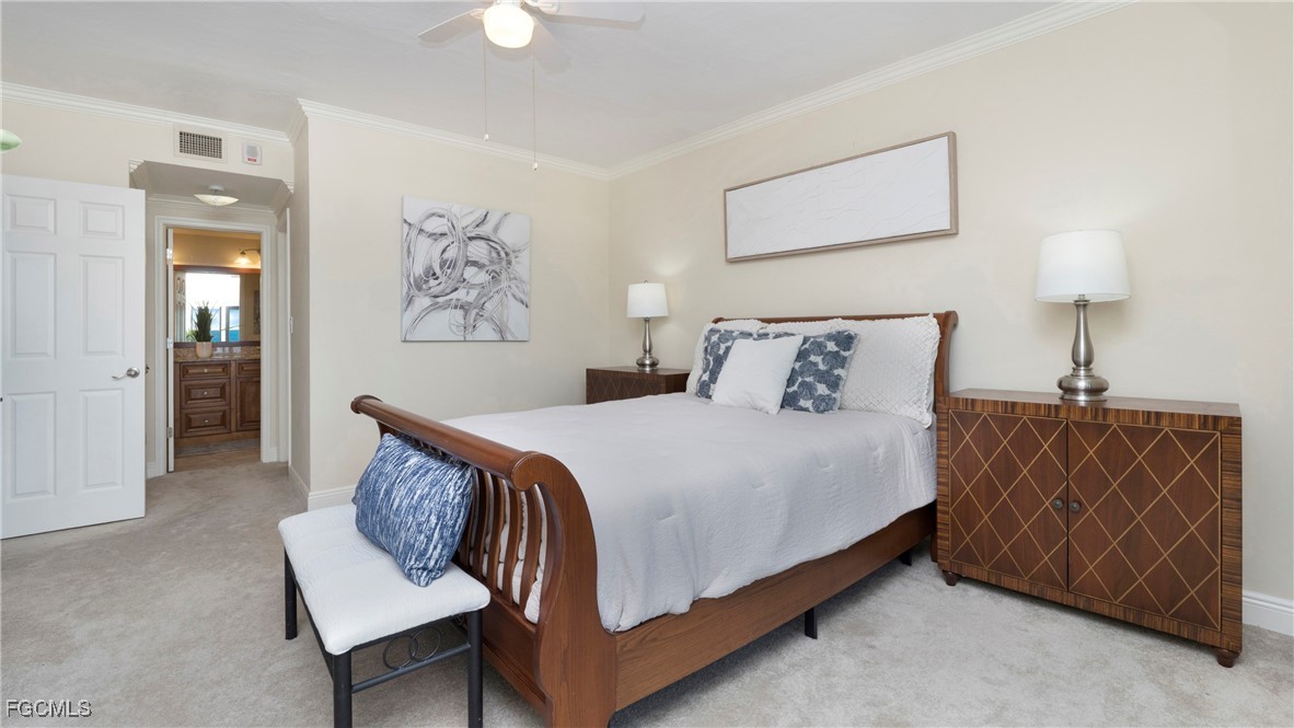 1920 Virginia Avenue, Unit 202 Fort Myers, FL 33901 - Photo 10 of 38 a bedroom with a bed and a lamp