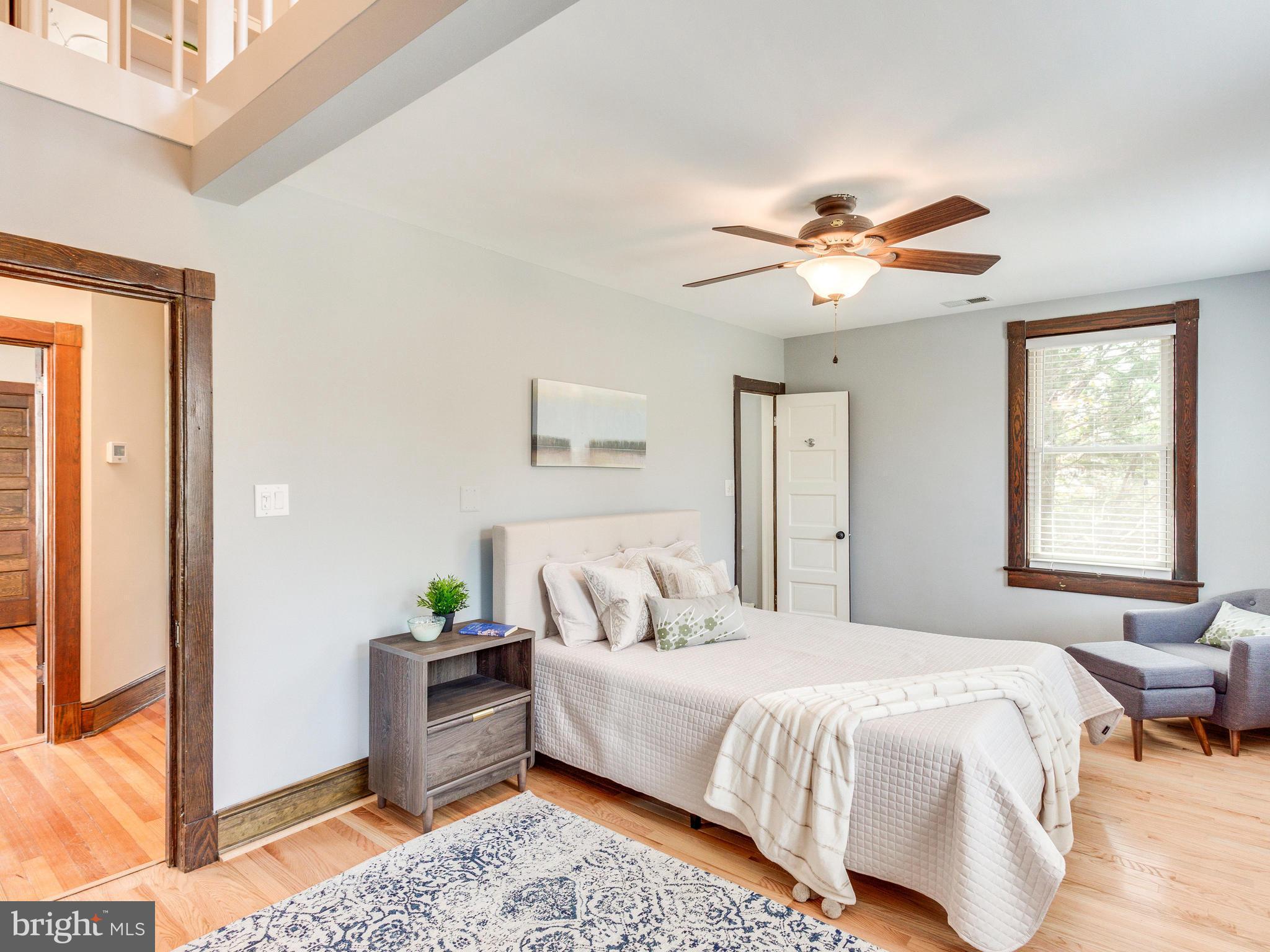 1107 Russell Road Alexandria, VA 22301 - Photo 13 of 29 a spacious bedroom with a bed and a chandelier