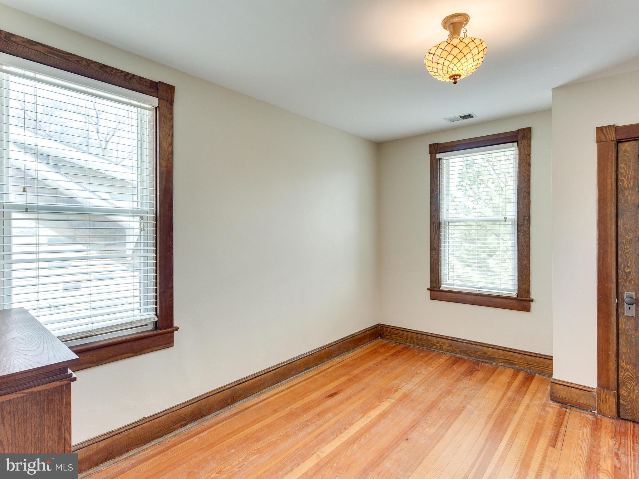 1107 Russell Road Alexandria, VA 22301 - Photo 21 of 29 a view of an empty room with a window and wooden floor