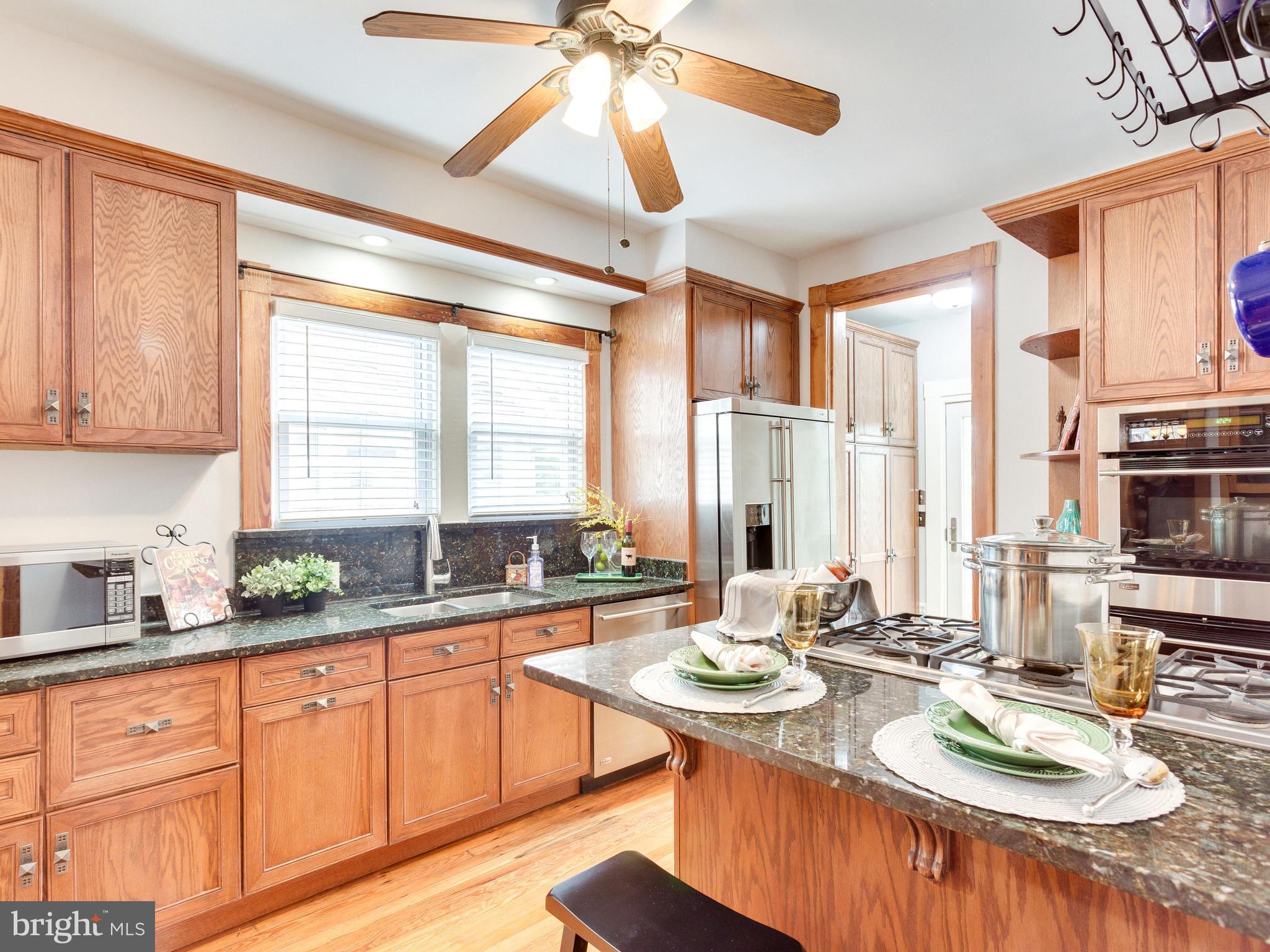 1107 Russell Road Alexandria, VA 22301 - Photo 9 of 29 a kitchen with sink refrigerator dining table and chairs