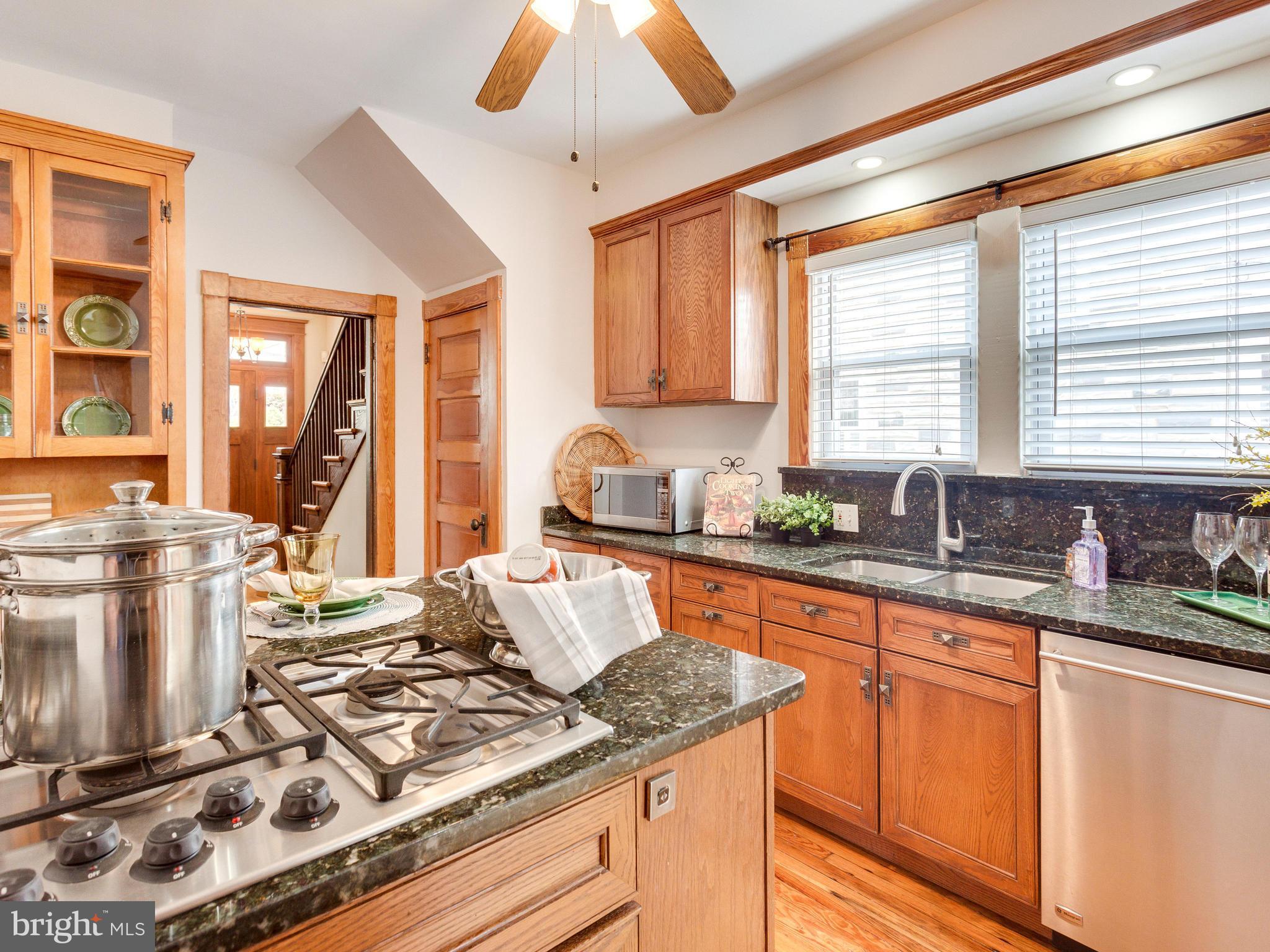 1107 Russell Road Alexandria, VA 22301 - Photo 10 of 29 a kitchen with a stove a sink a window and dining table