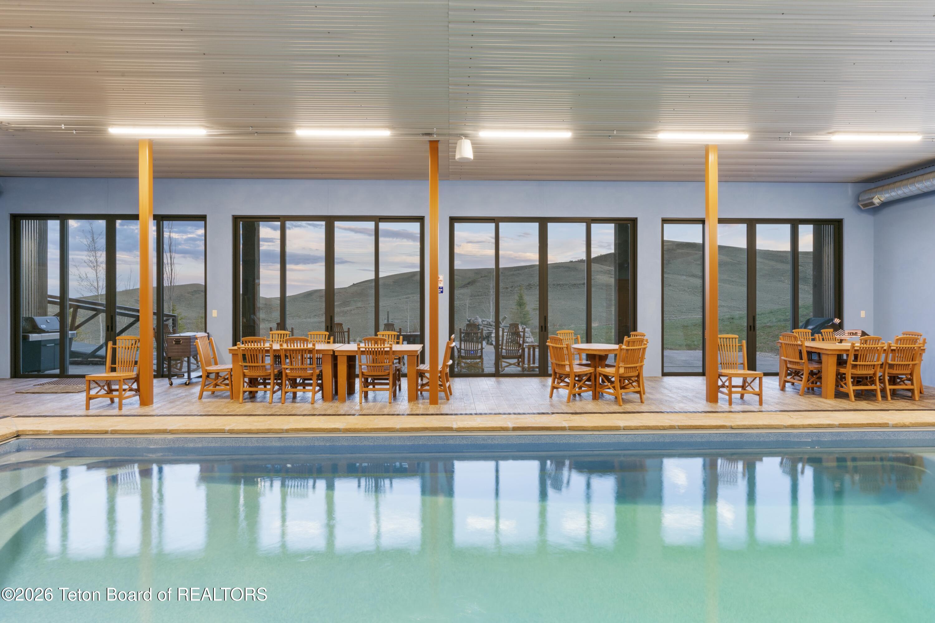 627 Ryegrass Road Daniel, WY 83115 - Photo 53 of 70 Pool with wall of Glass Doors