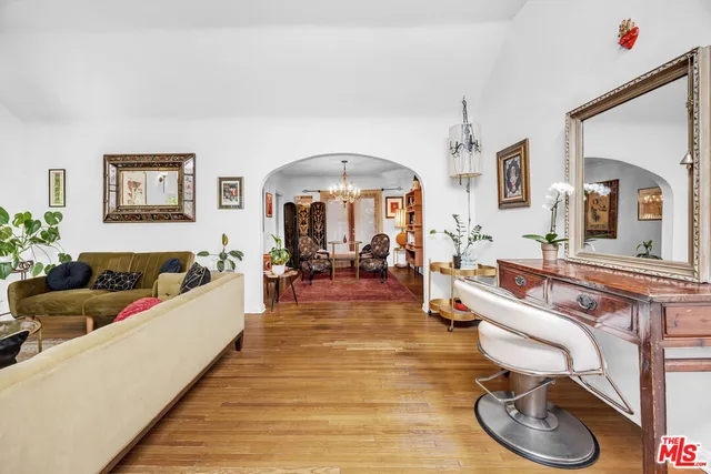 a living room with furniture and a chandelier