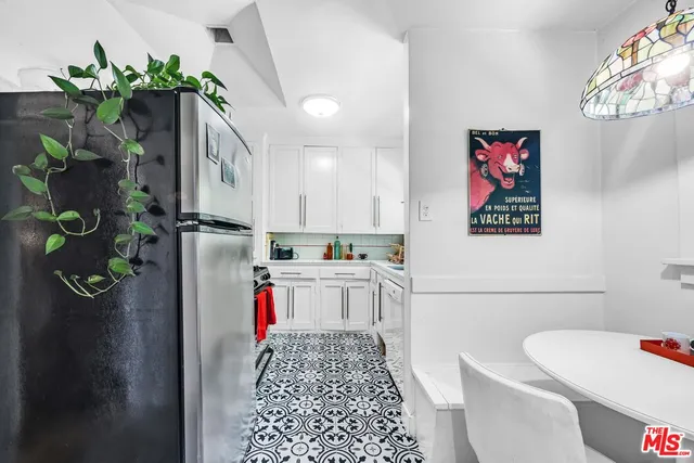 a kitchen with a refrigerator and a sink