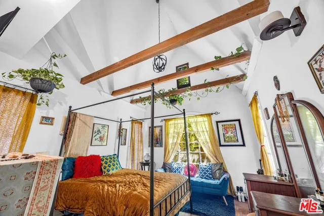 a bed room with a bed and a window