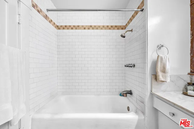 a bathroom with a shower curtain and a sink