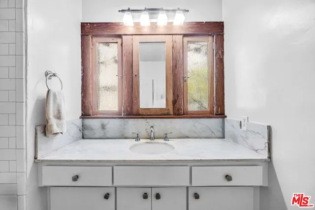 a bathroom with a sink and a mirror