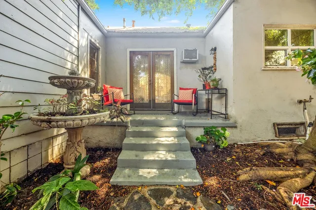 a lobby with furniture and potted plants