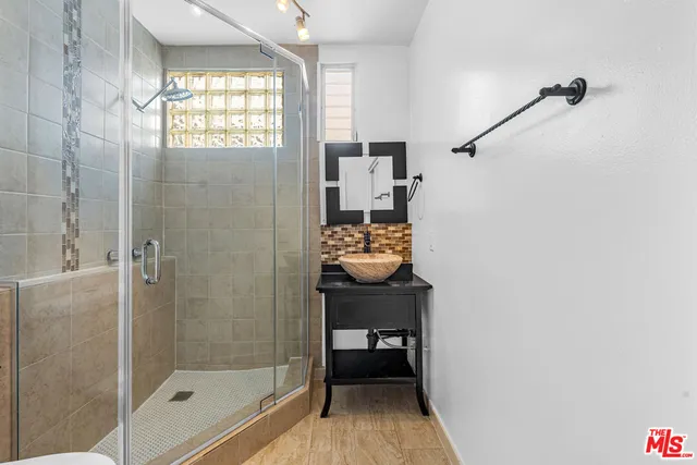 a bathroom with a sink toilet and shower