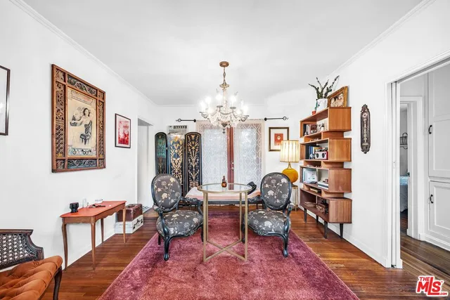 a living room with furniture a chandelier and a chandelier