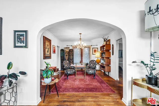 a living room with furniture and a chandelier