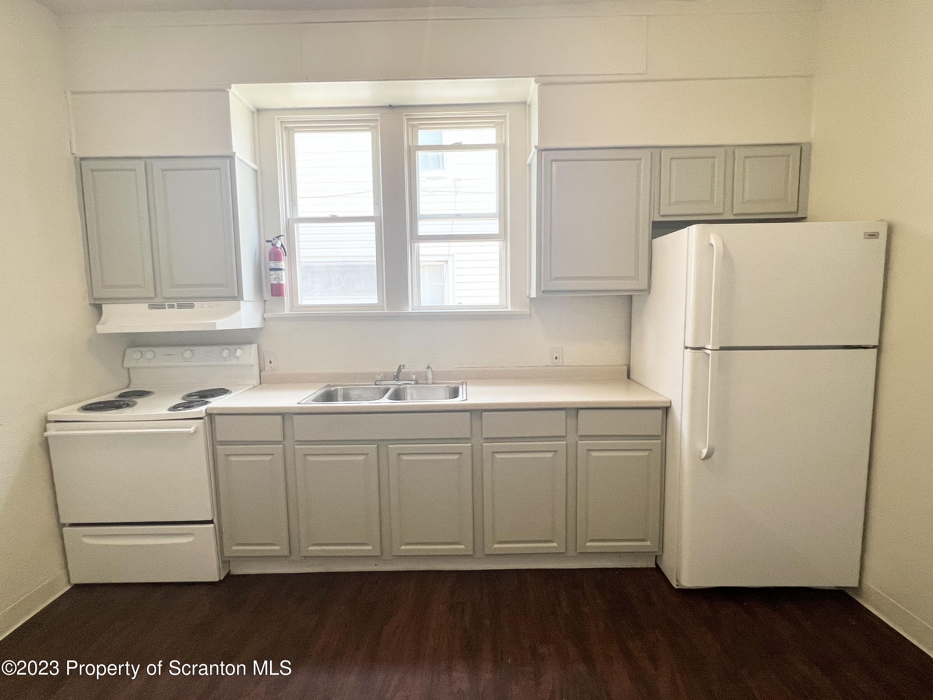 1930 Boulevard Avenue, Unit 1 Scranton, PA 18509 - Photo 2 of 9 a white refrigerator freezer sitting inside of a kitchen
