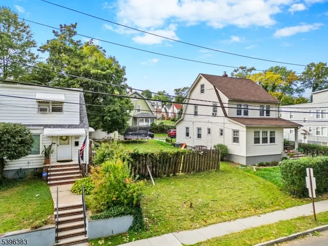 a front view of a house with a garden and plants
