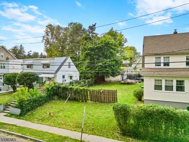 a view of a house with brick walls and a yard