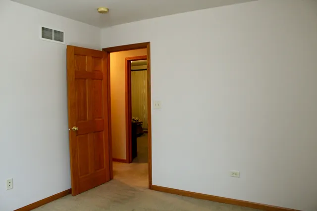 an empty room with closet area