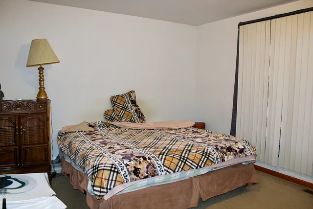 a bedroom with a bed and a window